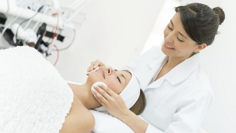Woman at the spa and masseuse doing a deep cleansing treatment on her client